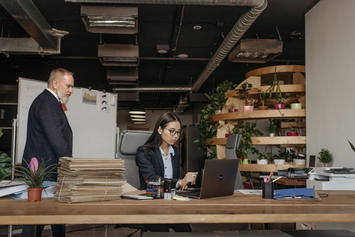Professional pausing thoughtfully at a desk to reflect before responding to an email
