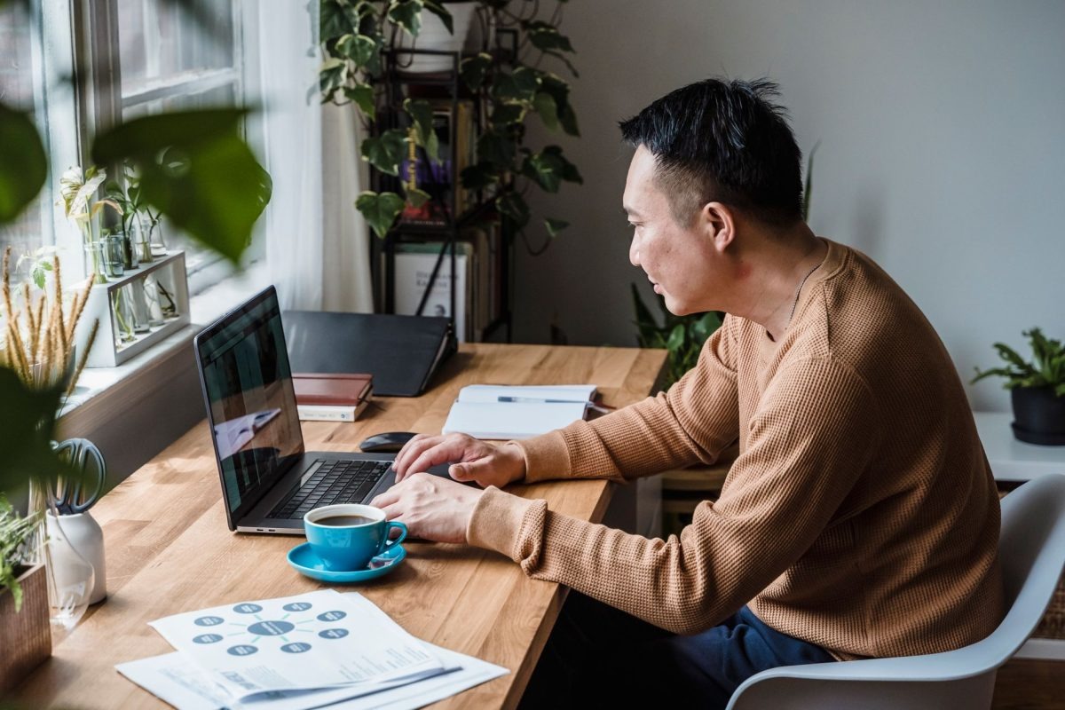 A professional focusing on work at a tidy desk in a quiet home office