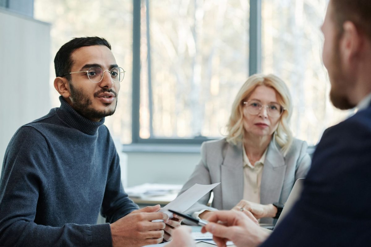 Two business professionals resolving a disagreement calmly in an office setting.