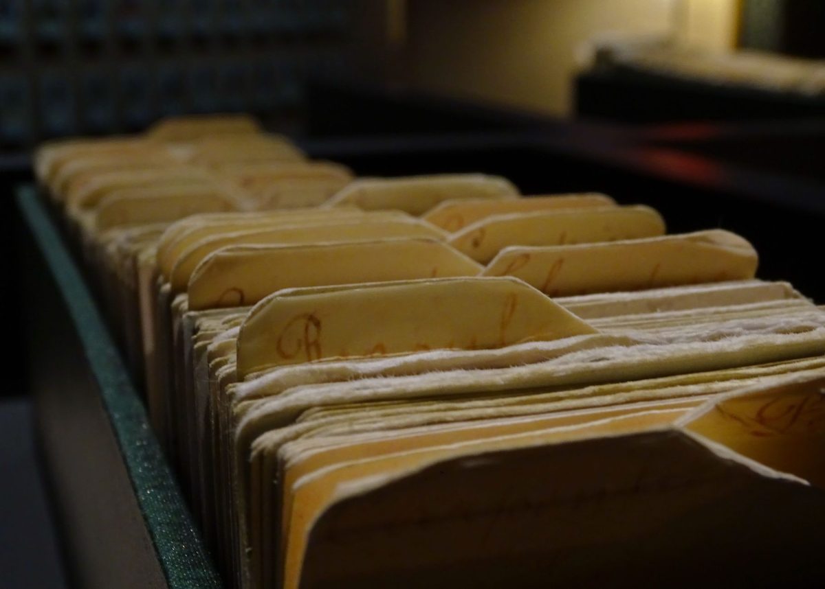 Historical reference books, vintage papers, and early twentieth-century academic documents in an archive