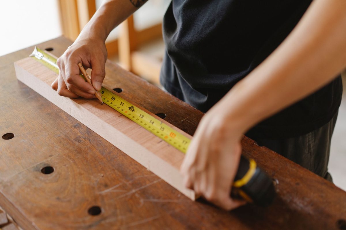 Skilled artisan focused on woodworking in a bright carpentry workshop