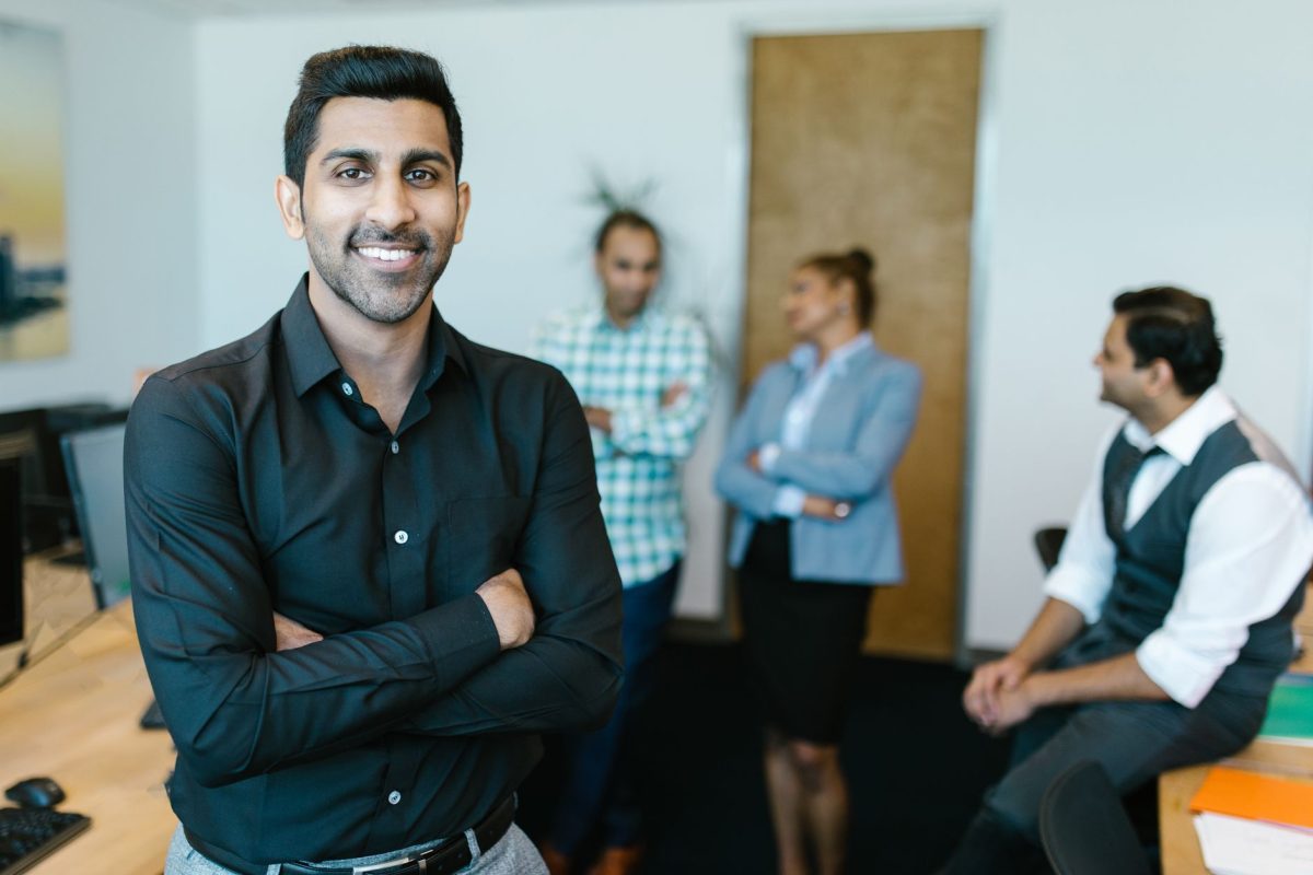 A composed manager communicating clearly and listening to team members in a conference room